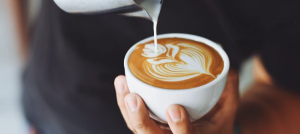 person performing coffee art