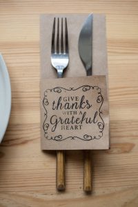 fork and knife in paper cover with inscription