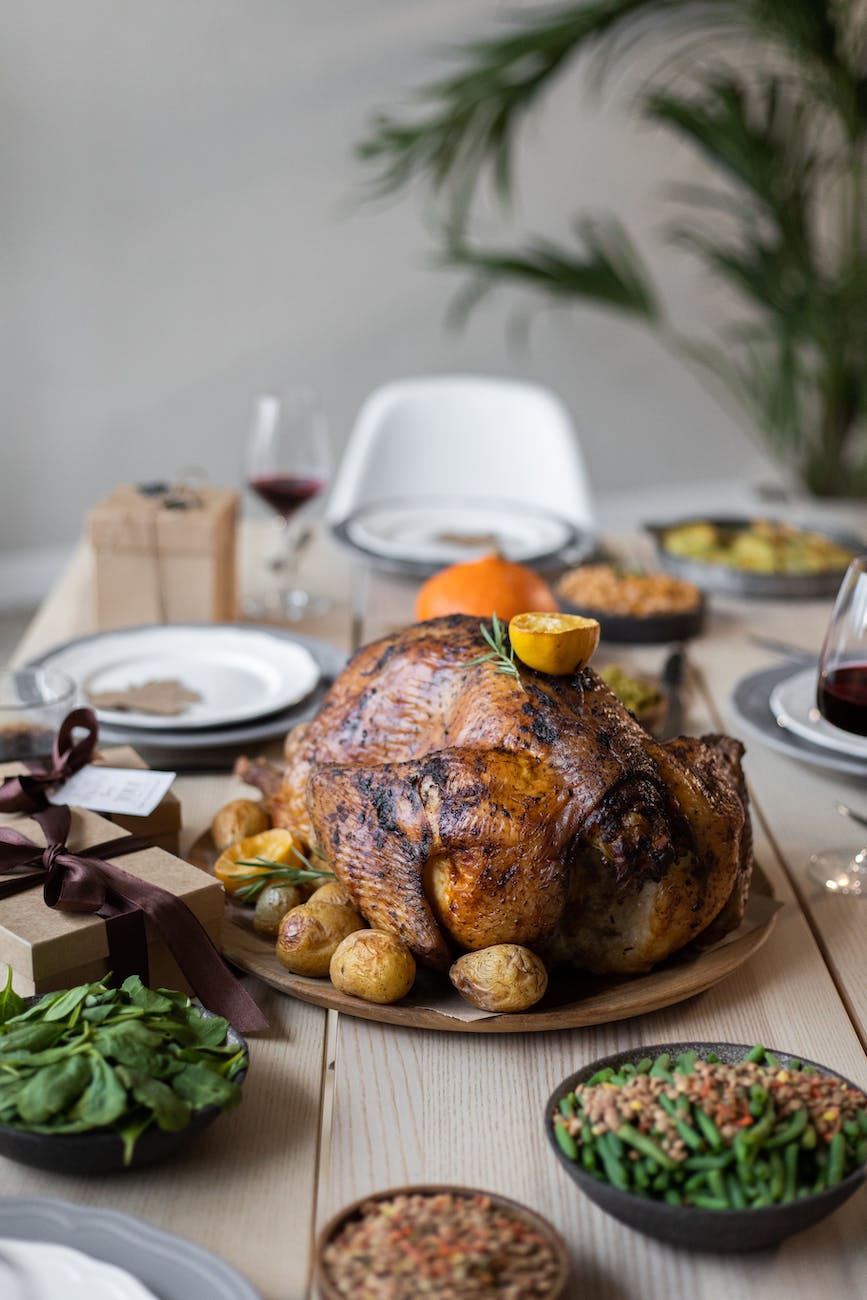 wooden table served with tasty dishes on thanksgiving day