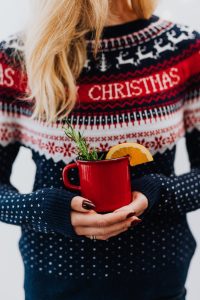 a person holding red ceramic mug