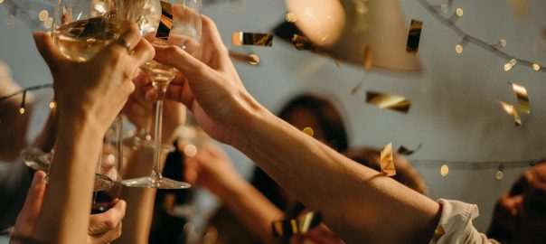 people toasting wine glasses
